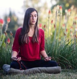 Young Woman meditating in nature