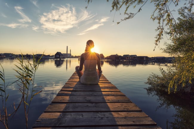 Woman Meditating at Lake