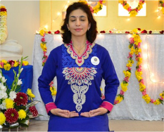 woman meditates with altar in background
